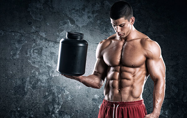 Bodybuilder-man-muscles-protein.jpg Мужчина держит в руке банку с протеином